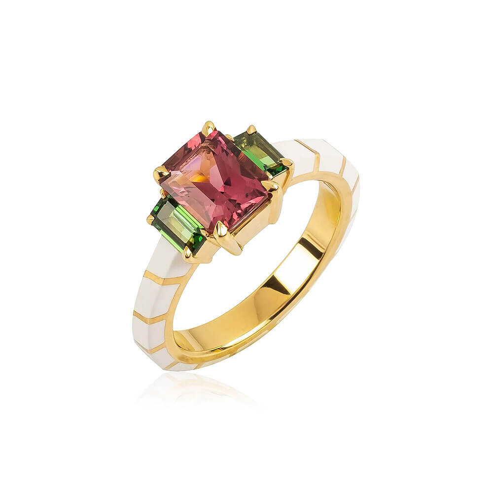 3 stone ring with a Red Tourmaline center stone and green tsavorites garnets on the sides set in 18k yellow gold and white hyceram