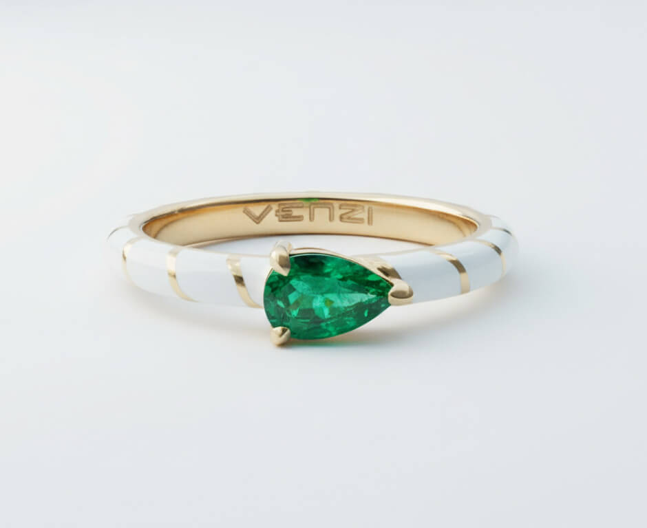 pear shape Colombian emerald approximately 1/2 carat set in 18k yellow gold wrap around white ceramic