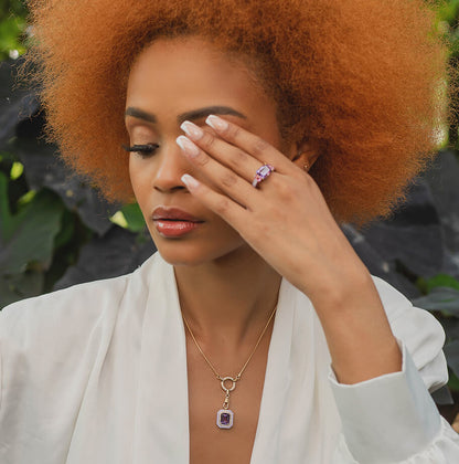 model wearing an amethyst pendant with diamonds set in 18 carat gold and light purple ceramic