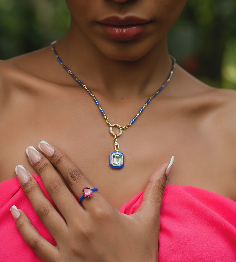 Model wearing a Statement ring, rubellite set in 14 carat yellow gold and Blue Ceramic