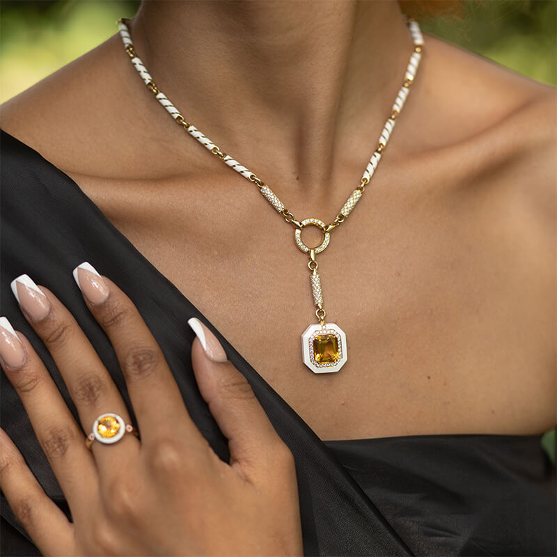 model wearing an 18 carat gold chain with diamonds and white ceramic 